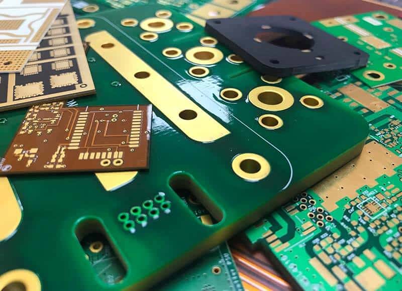 Close-up of various colorful printed circuit boards stacked together.