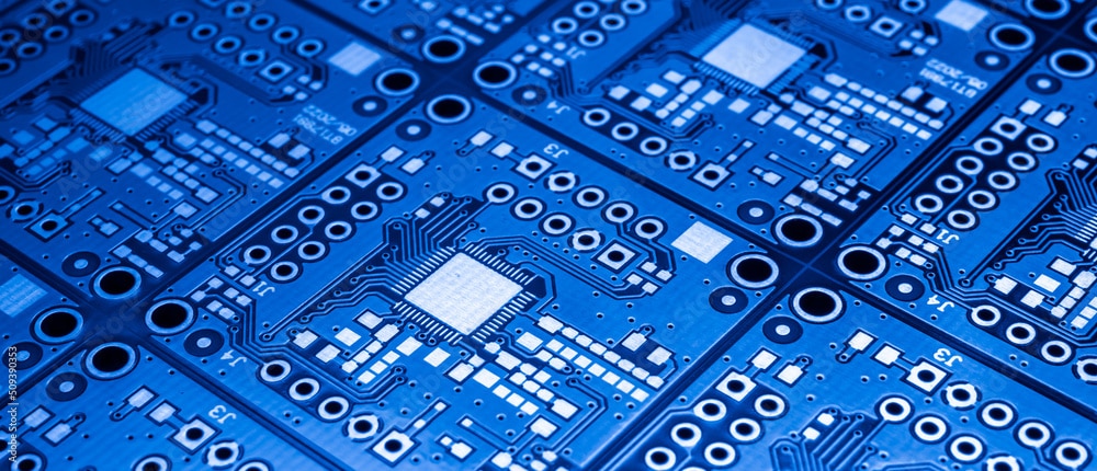 Close-up view of several blue printed circuit boards with electronic components and traces.