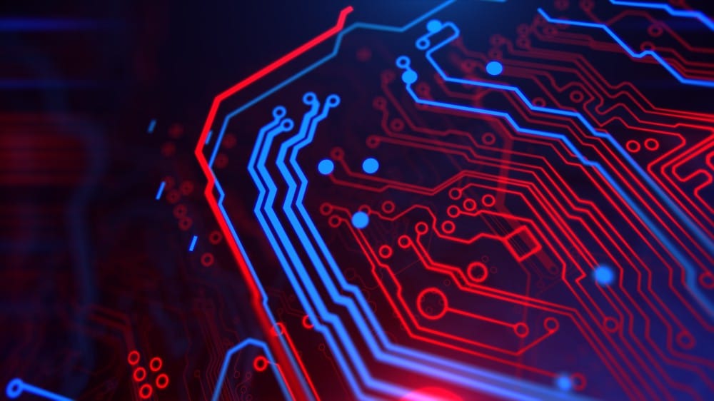 Glowing red and blue lines on a circuit board, representing digital technology and electronics.